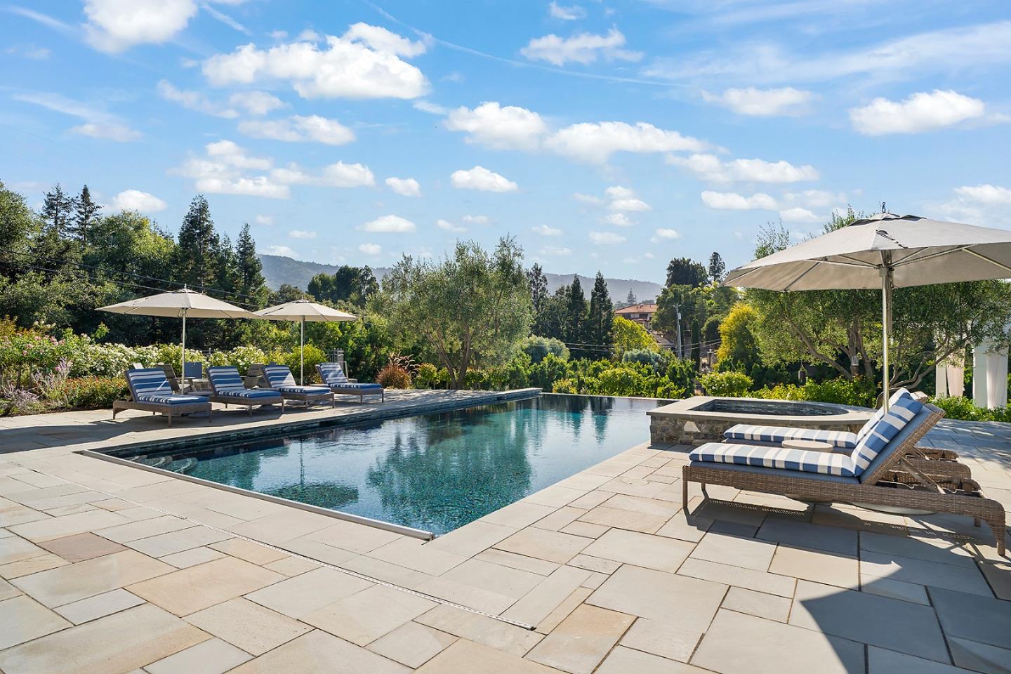 14966 Sobey Road Saratoga, CA 95070 - Photo 56 of 70 a view of a swimming pool with a table and chairs under an umbrella