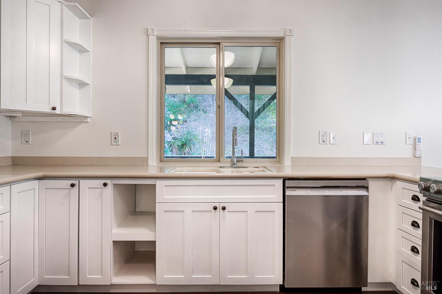 19500 Mountain View Road Boonville, CA 95415 - Photo 12 of 67 a kitchen with white cabinets and a window