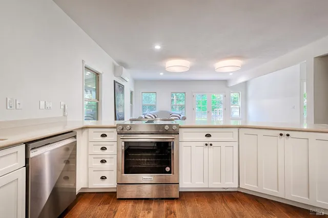 a living room with furniture wooden floor and a table