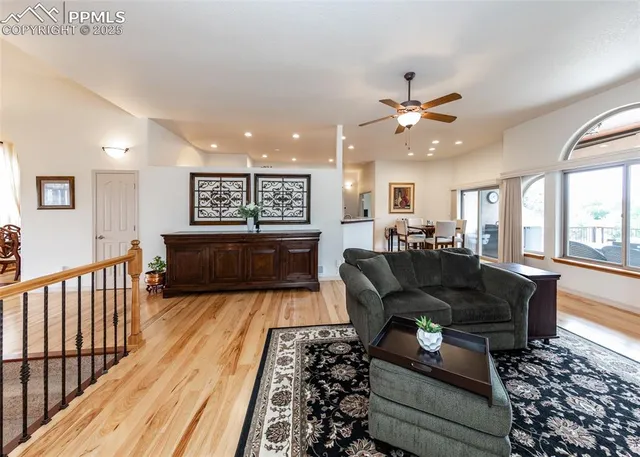 a living room with furniture ceiling fan and a rug