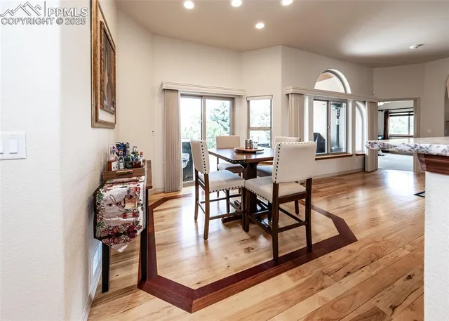 a view of a dining room with furniture window and wooden floor