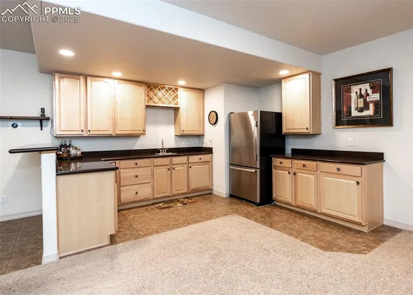 a kitchen with stainless steel appliances a refrigerator sink and microwave