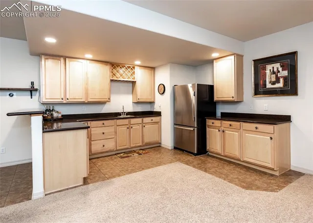 a kitchen with stainless steel appliances a refrigerator sink and microwave