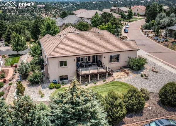 an aerial view of a house with swimming pool and outdoor seating
