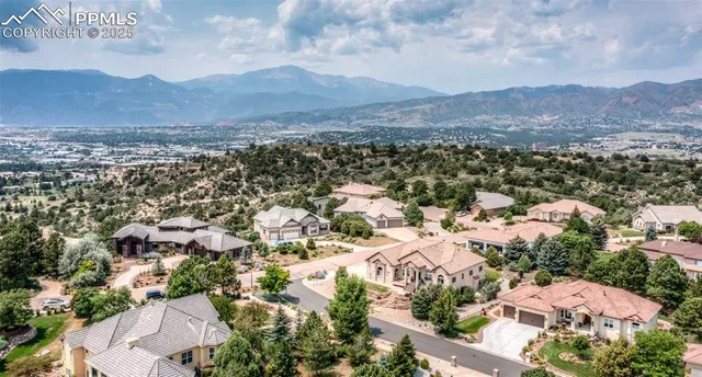 an aerial view of residential house and sandy dunes