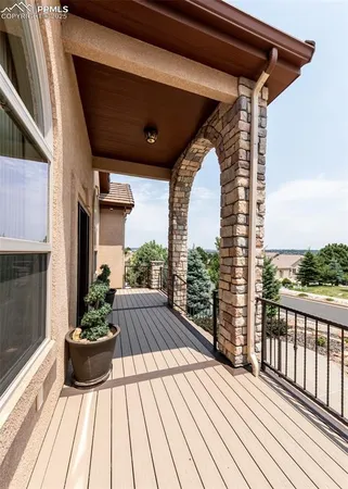 a view of balcony with wooden floor and outdoor seating