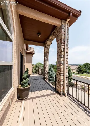 a view of balcony with wooden floor and outdoor seating
