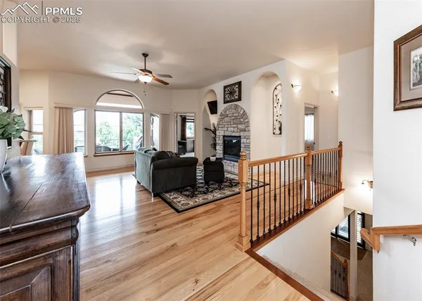 a view of a livingroom with wooden floor and furniture