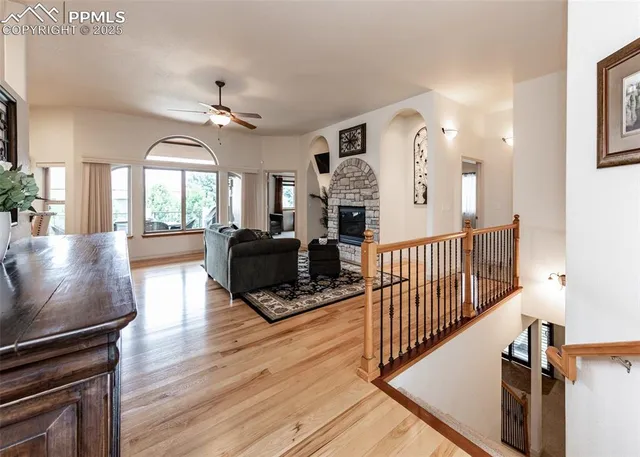 a view of a livingroom with wooden floor and furniture