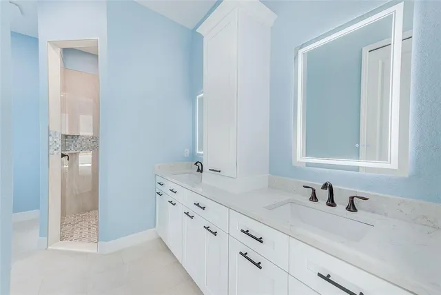 a bathroom with double sink and a mirror