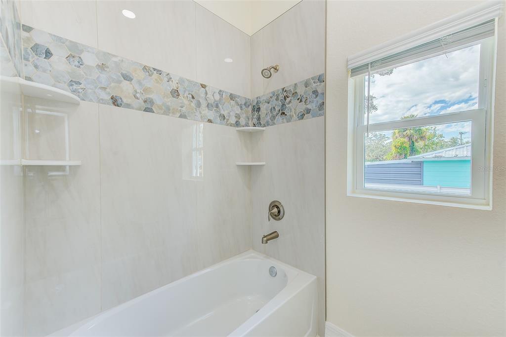 11111 Hackney Drive Riverview, FL 33578 - Photo 26 of 40 a bathroom with a bathtub and window