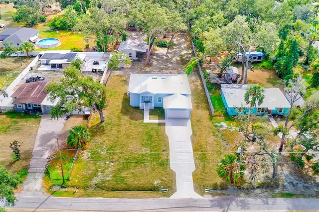 an aerial view of residential houses with outdoor space