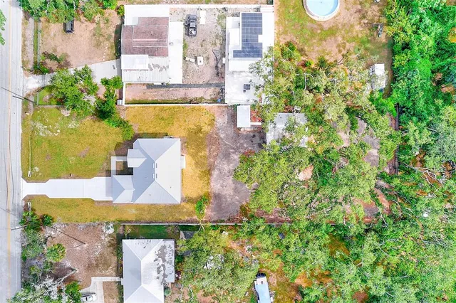 an aerial view of residential houses with outdoor space and swimming pool