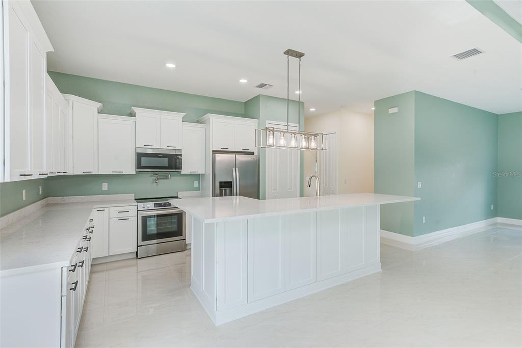 11111 Hackney Drive Riverview, FL 33578 - Photo 8 of 40 a large white kitchen with stainless steel appliances