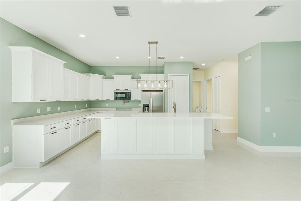 11111 Hackney Drive Riverview, FL 33578 - Photo 9 of 40 a kitchen with white cabinets and white appliances