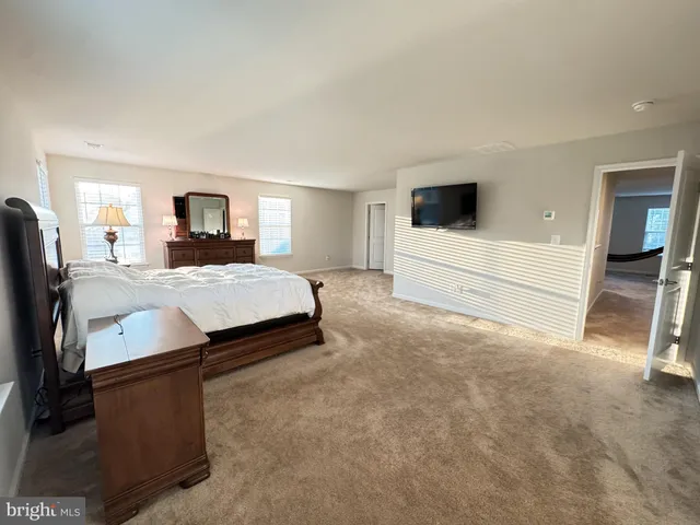 a bedroom with a bed and a television