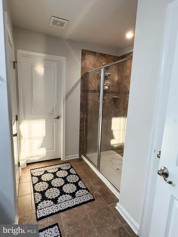 a bathroom with a glass shower door and a bathtub
