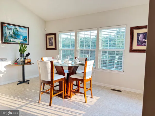 a dining room with furniture and window