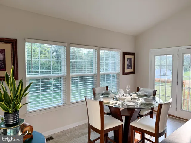 a dining room with furniture and window
