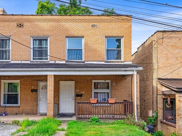 front view of a house with a yard