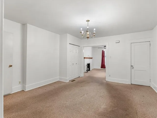 a view of a hallway with wooden floor and entryway