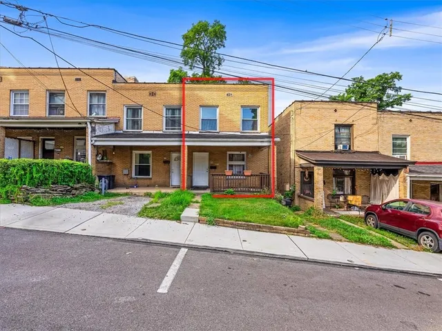 a view of a house with wooden fence