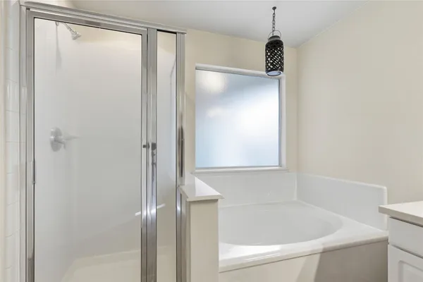 a bathroom with a bathtub and a shower