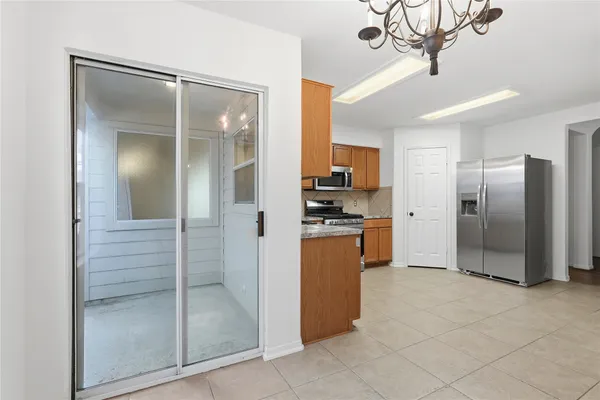 a view of a kitchen with refrigerator and cabinets