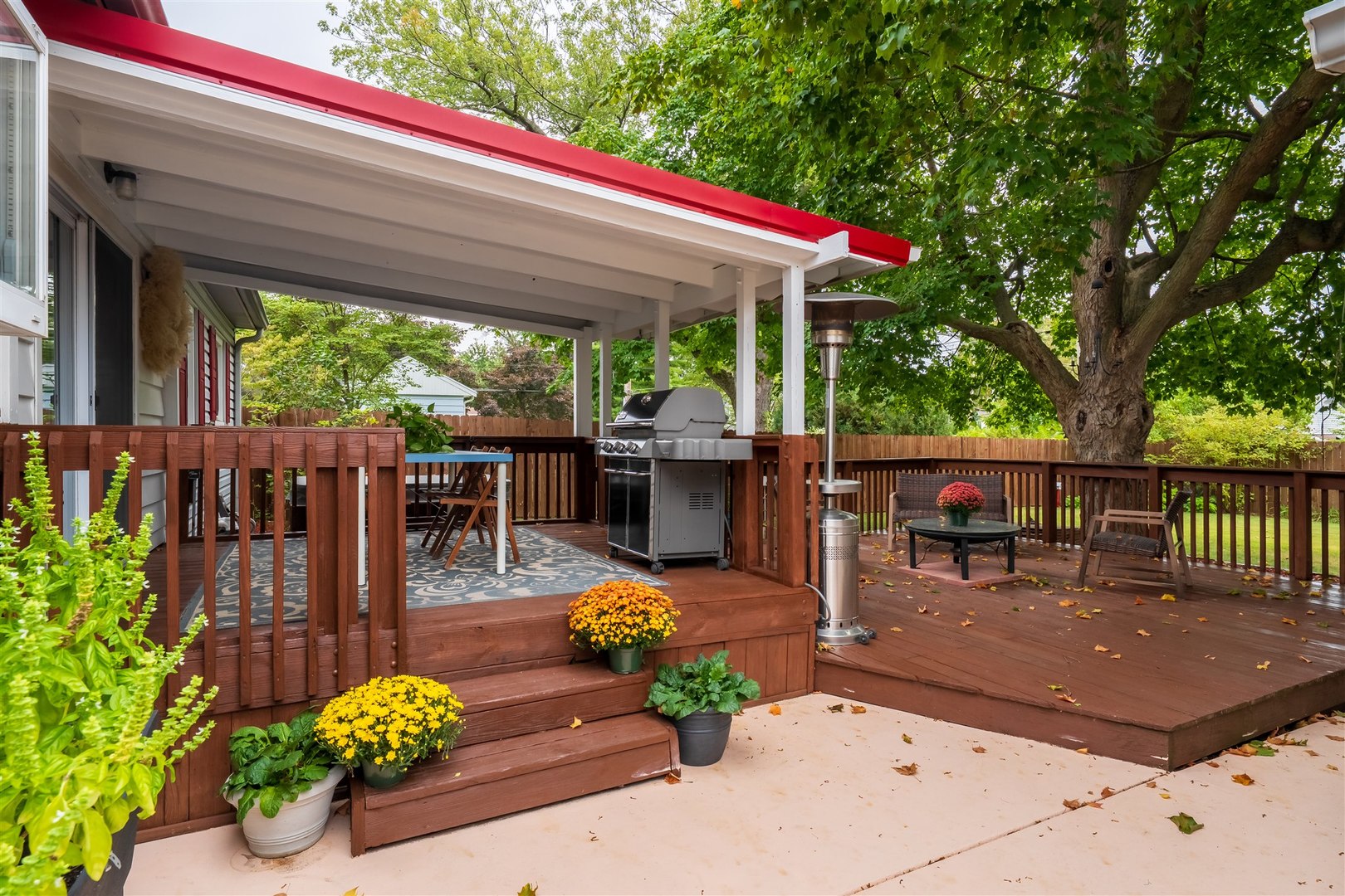 1103 Morgan Street Normal, IL 61761 - Photo 13 of 35 a view of a patio with couches table and chairs potted plants and floor to ceiling window