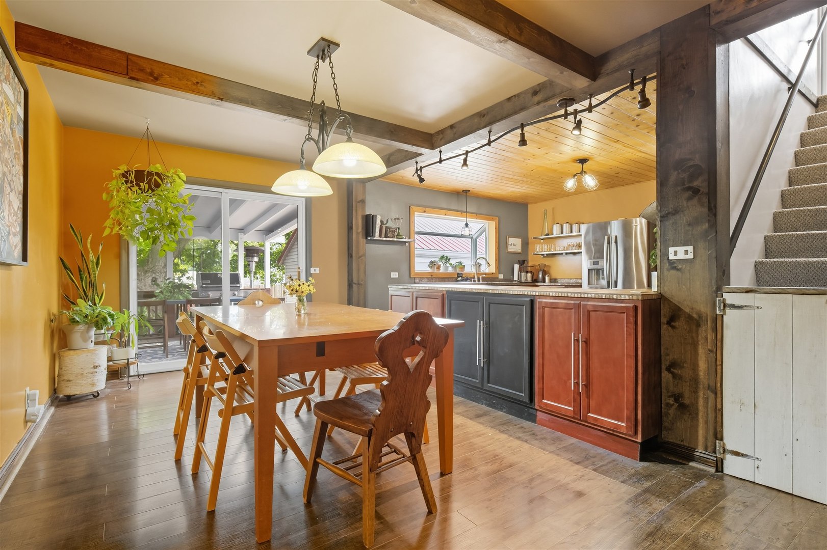 1103 Morgan Street Normal, IL 61761 - Photo 16 of 35 a dining room with wooden floor a chandelier a glass table and chairs