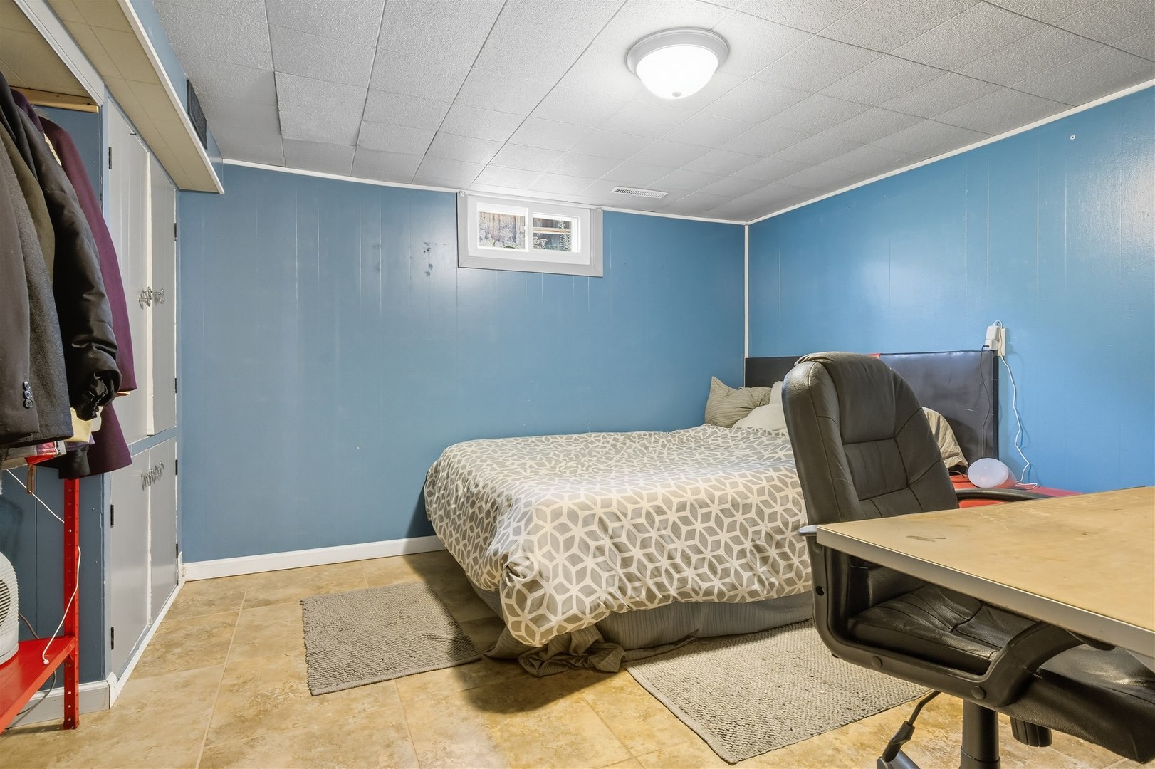 1103 Morgan Street Normal, IL 61761 - Photo 21 of 35 a bedroom with a bed a couch and a flat tv screen on the dresser