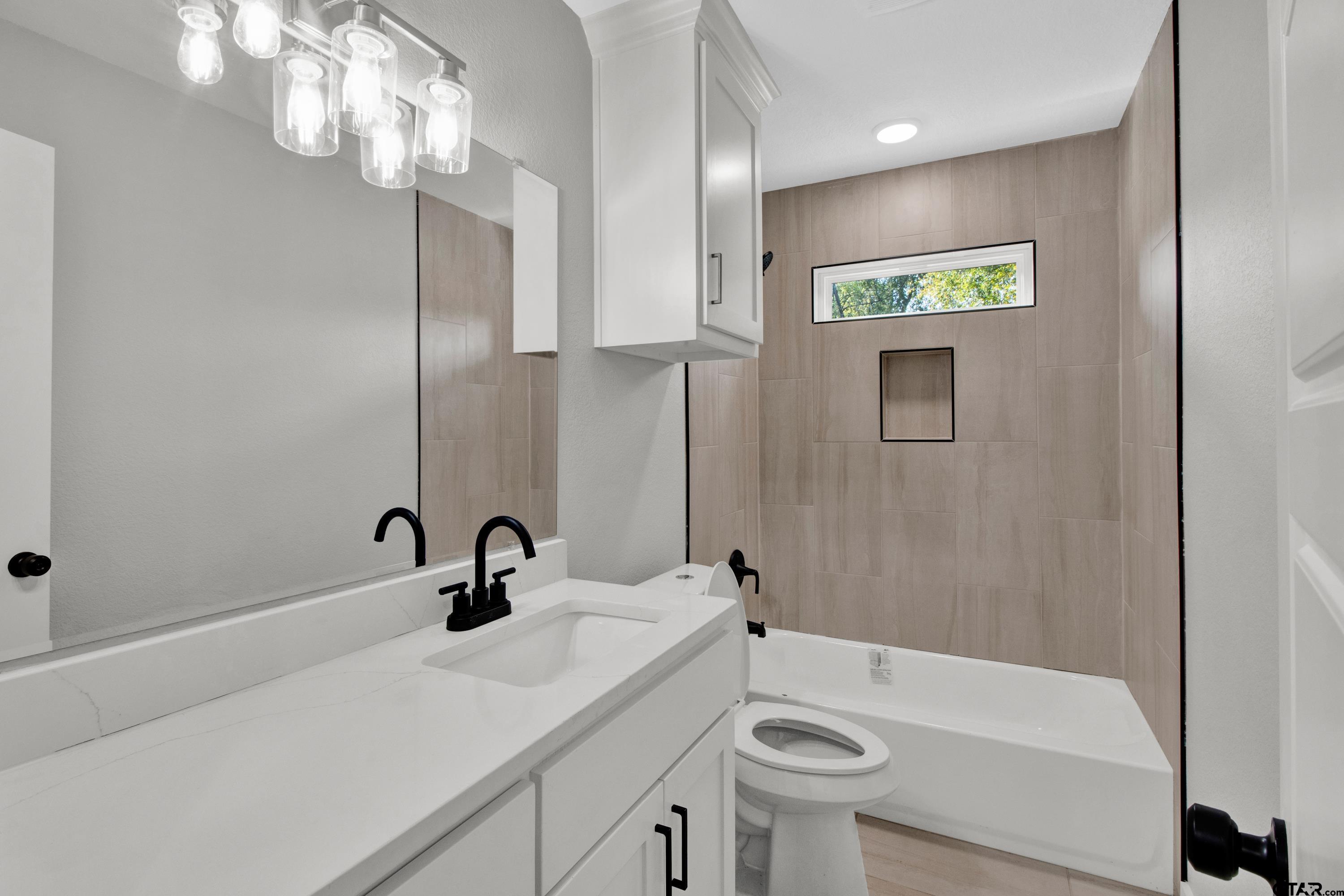 1448 Crescent Drive Tyler, TX 75702 - Photo 18 of 32 a bathroom with a sink a large mirror and shower