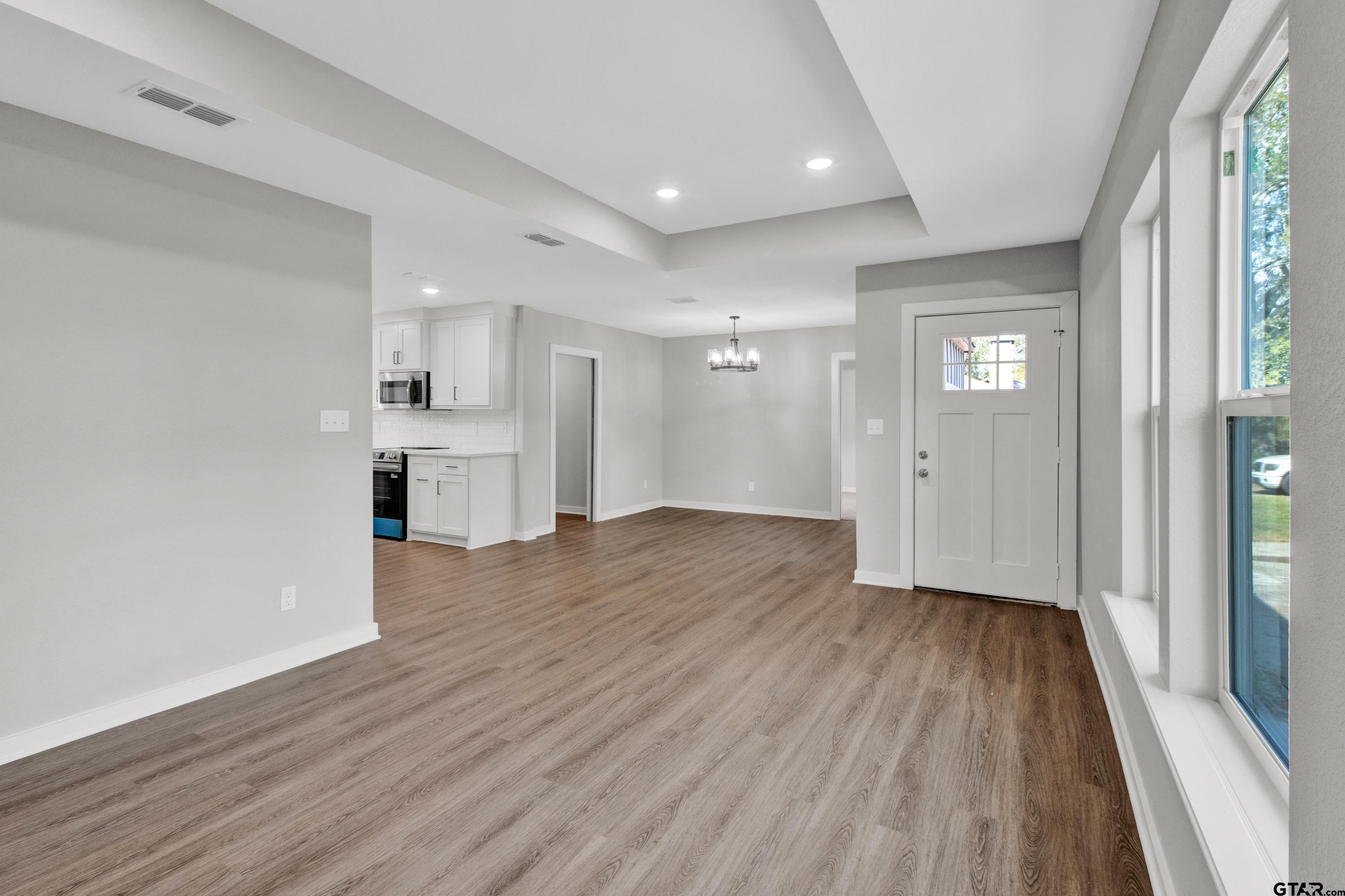 1448 Crescent Drive Tyler, TX 75702 - Photo 8 of 32 a view of empty room with wooden floor and window
