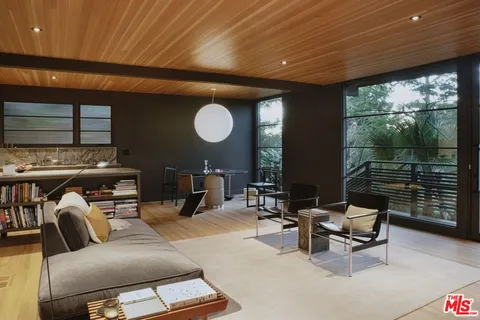 a dining room with furniture and wooden floor