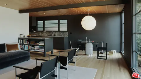 a living room with furniture and a ceiling fan