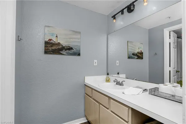 a bathroom with a sink a vanity and a mirror