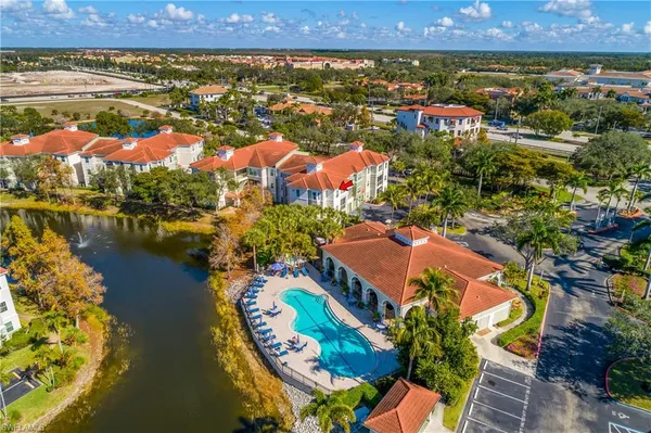 an aerial view of residential houses with outdoor space and swimming pool