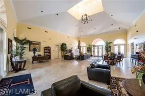 a living room with furniture and a large mirror