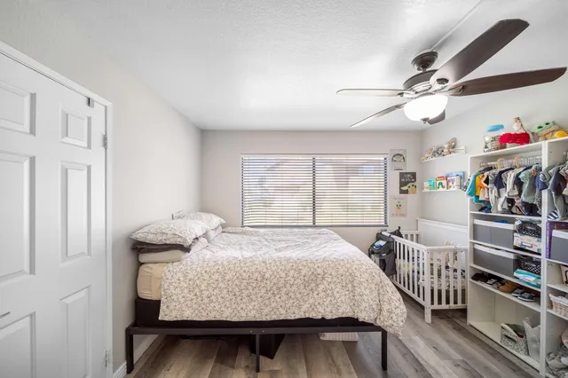 a bed sitting in a bedroom next to a window