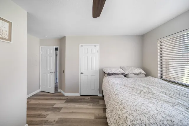 a bedroom with a bed and a window