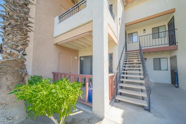 a view of front door of house with stairs