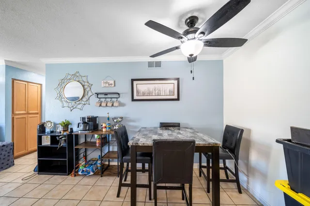 a view of a dining room with furniture and chandelier