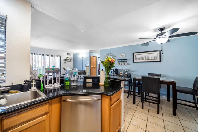 a kitchen with a dining table chairs and white cabinets