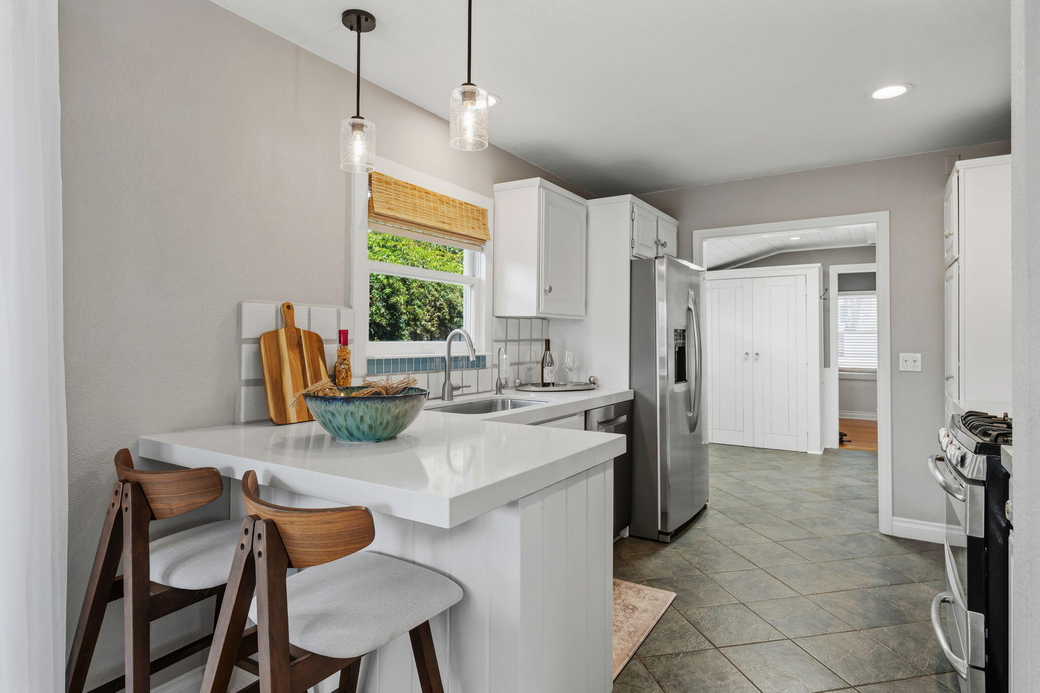 2129 Red Rose Way Santa Barbara, CA 93109 - Photo 4 of 44 a kitchen with a dining table chairs and refrigerator