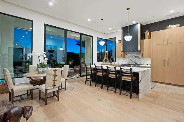 a large kitchen with kitchen island a large window in it