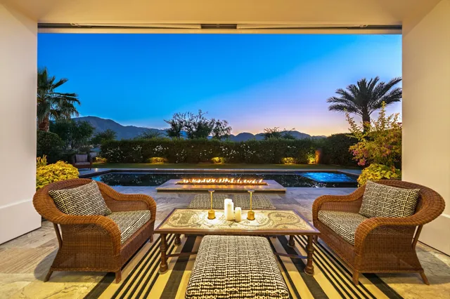 a living room with furniture a flat screen tv and a clock