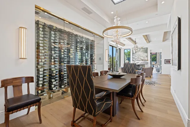 a living room with furniture a dining table and a chandelier