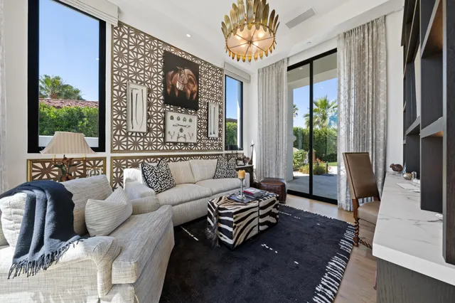 a bedroom with furniture and a flat screen tv
