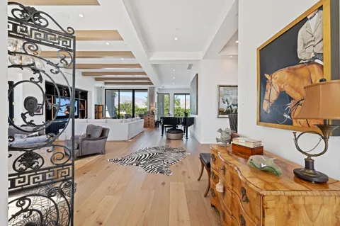a living room with fireplace furniture and a large window