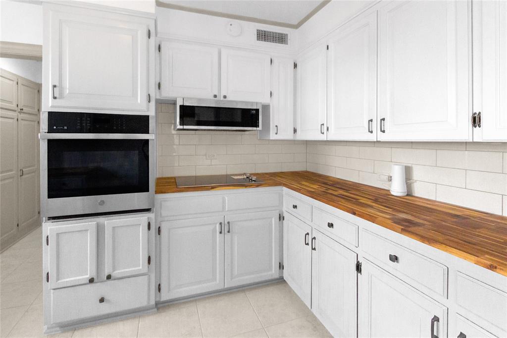 401 West 4th Street Tyler, TX 75701 - Photo 13 of 34 a kitchen with white cabinets and white appliances